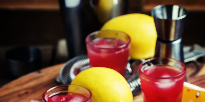 Watermelon ale, alcoholic cocktail with pulp of watermelon, ice and lemon juice, vintage wooden background, selective focus