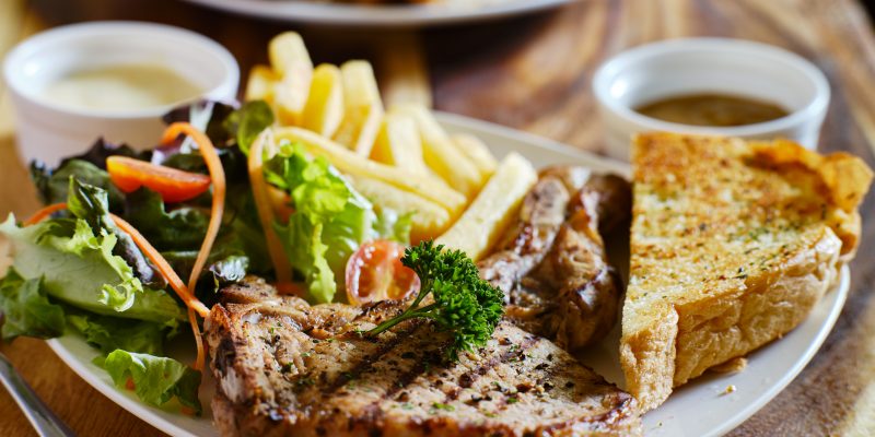 grilled pork chop with french fries and salad thai style